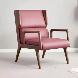 Home Modern armchair with dark wood frame and pink leather seat in a minimalist interior.